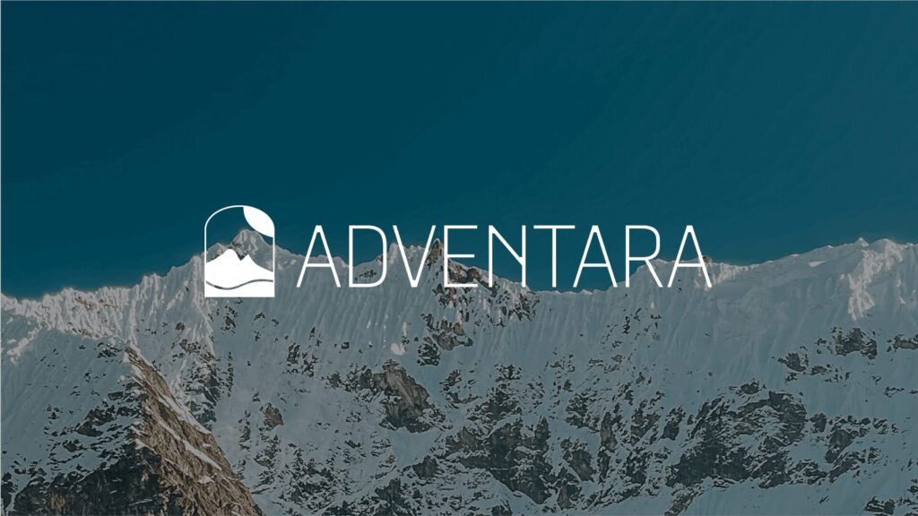 travel blog logo in front of snowy mountains on a clear day